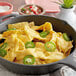 A skillet of nachos with Carnival King cheddar cheese sauce and jalapenos.