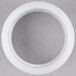 A white plastic Nemco slotted bushing on a grey surface.