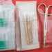 A pack of Medique cotton tip applicators in clear plastic containers with scissors and tweezers.