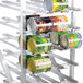A Winholt aluminum stationary can rack filled with canned food.