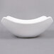A white American Metalcraft square stoneware bowl on a gray background.