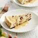 A slice of cheesecake on a plate with DaVinci Gourmet White Chocolate sauce.