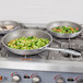 A Vollrath Wear-Ever non-stick frying pan with broccoli and corn cooking inside.