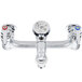 A T&S chrome mop sink faucet with two valves.