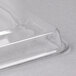 A clear plastic rectangular tray cover on a white surface.