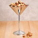 An American Metalcraft stainless steel martini glass filled with mixed nuts.
