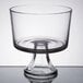 An Anchor Hocking clear glass trifle bowl with a base.