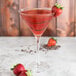 A Chef & Sommelier martini glass filled with red liquid and strawberries.