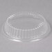 A Dart clear plastic container lid with a scalloped edge.