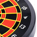 An Arachnid CricketPro electronic dart board with red and black stripes and numbers.