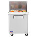 A Turbo Air stainless steel sandwich prep table with a large refrigerated compartment.
