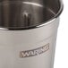 A stainless steel Waring malt cup on a counter.