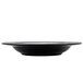 A black melamine bowl with a white etched design on the rim.