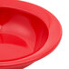 A close up of a red Carlisle Dallas Ware fruit bowl.