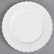 A white WNA Comet Classicware plastic plate with a circular design.