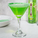 A martini glass with a green drink rimmed with Rokz Apple Cocktail Rimming Sugar.