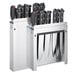 An Edlund stainless steel knife rack with many knives in it.