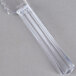 A clear plastic bread knife with a white handle.