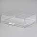 A clear plastic display case with a white handle.