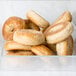 A clear container filled with bagels.