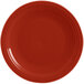 A close-up of a red Fiesta® round chop plate with a rim.