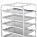 A Winholt metal tray rack with four shelves holding metal trays.