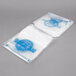 A stack of white Printed Plastic Deli Saddle Bags with blue designs.