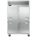 A silver Traulsen reach-in refrigerator with half doors.