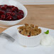 A plate of cherry cobbler with a fork and bowl of Lucky Leaf Cherry Cobbler filling.