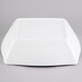 A white square bowl with rounded corners on a gray surface.