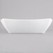A white rectangular bowl on a gray background.