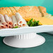 A tray of food on a white melamine pedestal.
