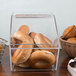 A clear plastic Cal-Mil food bin filled with bagels on a hotel buffet counter.