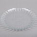A clear glass Libbey salad plate with a flower design.