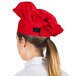 A woman wearing a red Choice chef hat.