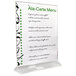 A Cal-Mil clear acrylic displayette with a menu card featuring black and green writing on a stand.