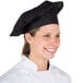 A woman wearing a black Choice customizable chef hat.