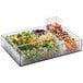 A clear acrylic container with a variety of vegetables on a salad bar.