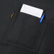 A black Chef Revival bistro apron pocket with a pen and a piece of paper.