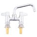 A chrome Equip by T&S deck mount swing faucet with two brass handles.