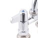 An Equip by T&S deck-mount faucet with 4" adjustable centers and two blue handles.