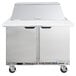 A Beverage-Air stainless steel refrigerated sandwich prep table with two doors and a top shelf.