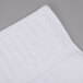 A white Oxford Signature bath sheet with a stripe on it.