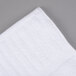 An Oxford Signature white bath towel with a stripe pattern.