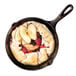 A Lodge cast iron skillet with a fruit pie in it.