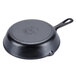 A Lodge black cast iron skillet with a handle.
