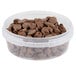 A clear plastic deli container filled with chocolate chips.