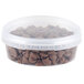 A clear plastic 8 oz. deli container filled with chocolate chips.