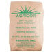 A brown Agricor bag with green text and a green starburst label for coarse yellow cornmeal.