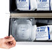 A hand holding a box of Polar Tech Re-Freez-R-Brix foam freeze packs.